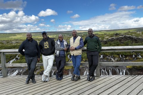 The delegation, from left: Dr Lawrence Orikiriza, Dr Jerome S. Lugumira, Dr Enock Ssekuubwa, a former GRÓ LRT fellow, Dr Daniel Waiswa and Dr Gerald Eilu at Hraunfossar Waterfalls in Borgarfjörður.